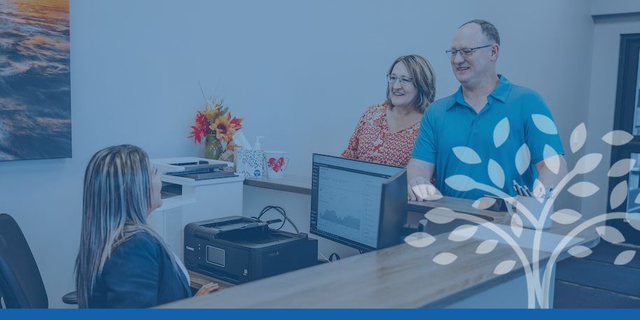 two people talking to receptionist at owatonna, mn principal location