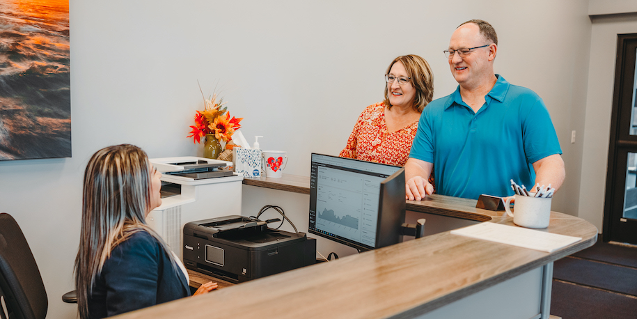 two people talking to receptionist at owatonna, mn principal location